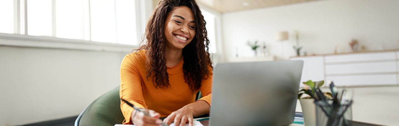 Female student sitting at desk using a laptop computer