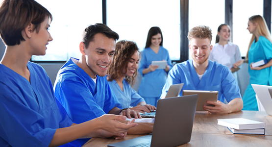Pharmacy technician students using a laptop to study for the PTCE exam